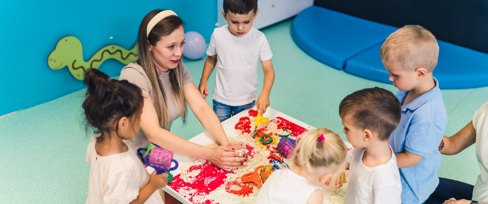 Childcare worker playing with children