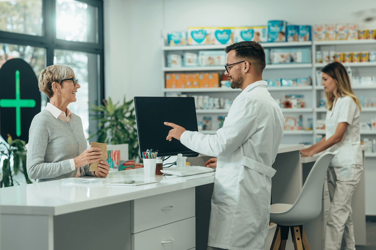 An image of a pharmacy tech serving a customer.