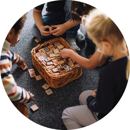 Three preschool children play with blocks.